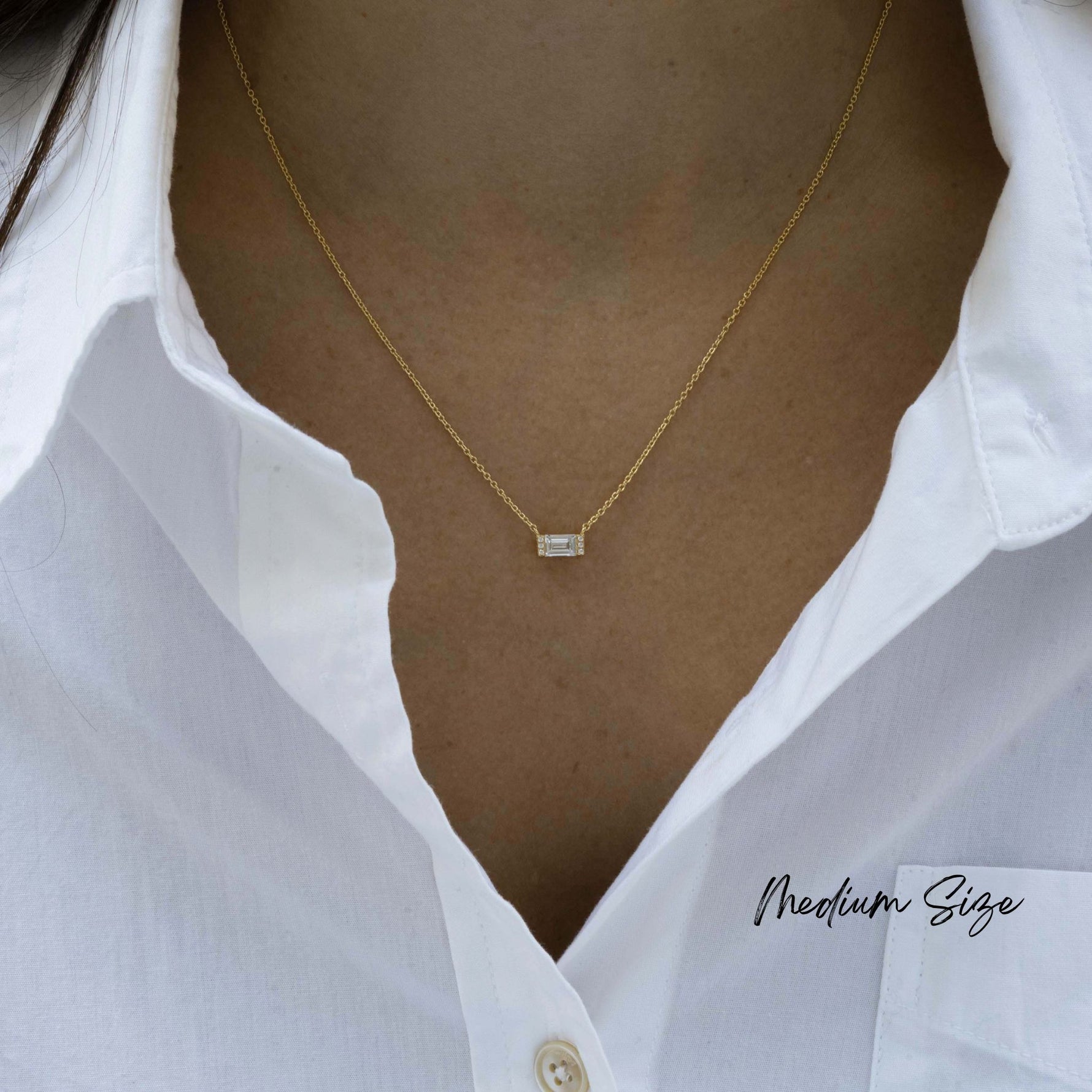 Model wearing medium size baguette pendant necklace with gold chain. 