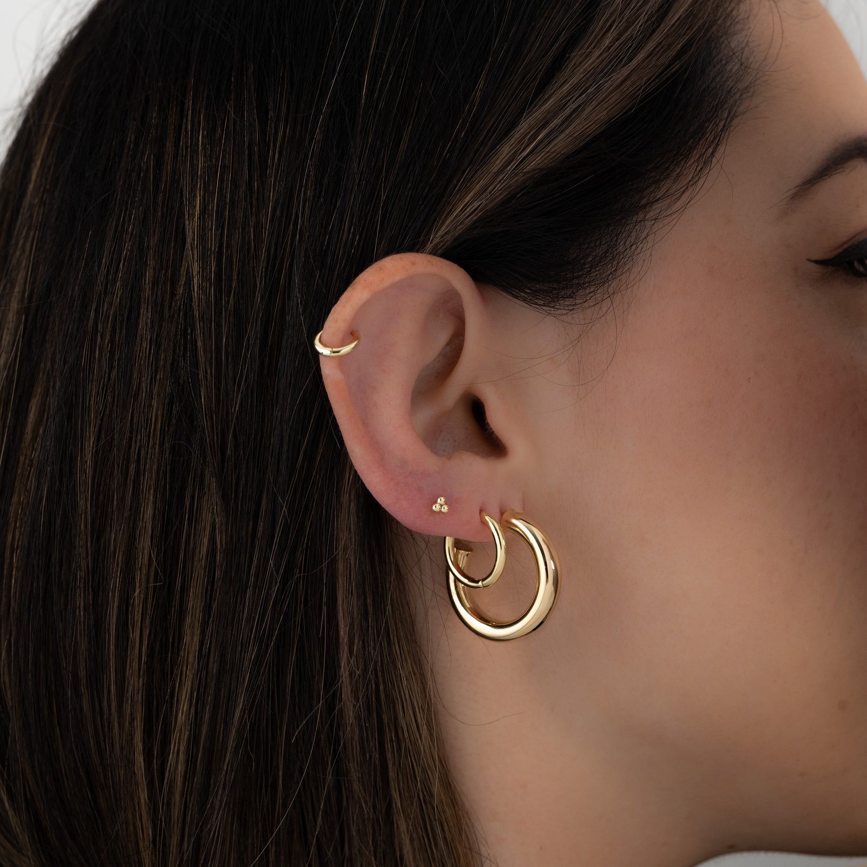 Madison Beer gold hoop earrings. 