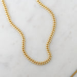 Gold cuban link chain necklace with cz stones throughout.