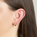 Model wearing delicate gold opal earring stack including a dainty sunburst opal stud earring.