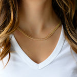Model wearing chunky gold curb link chain necklace. 