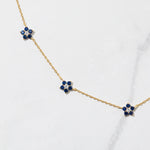 Close-up of sapphire flower gemstone necklace.