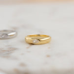 Gold dome ring in soft studio lighting. 