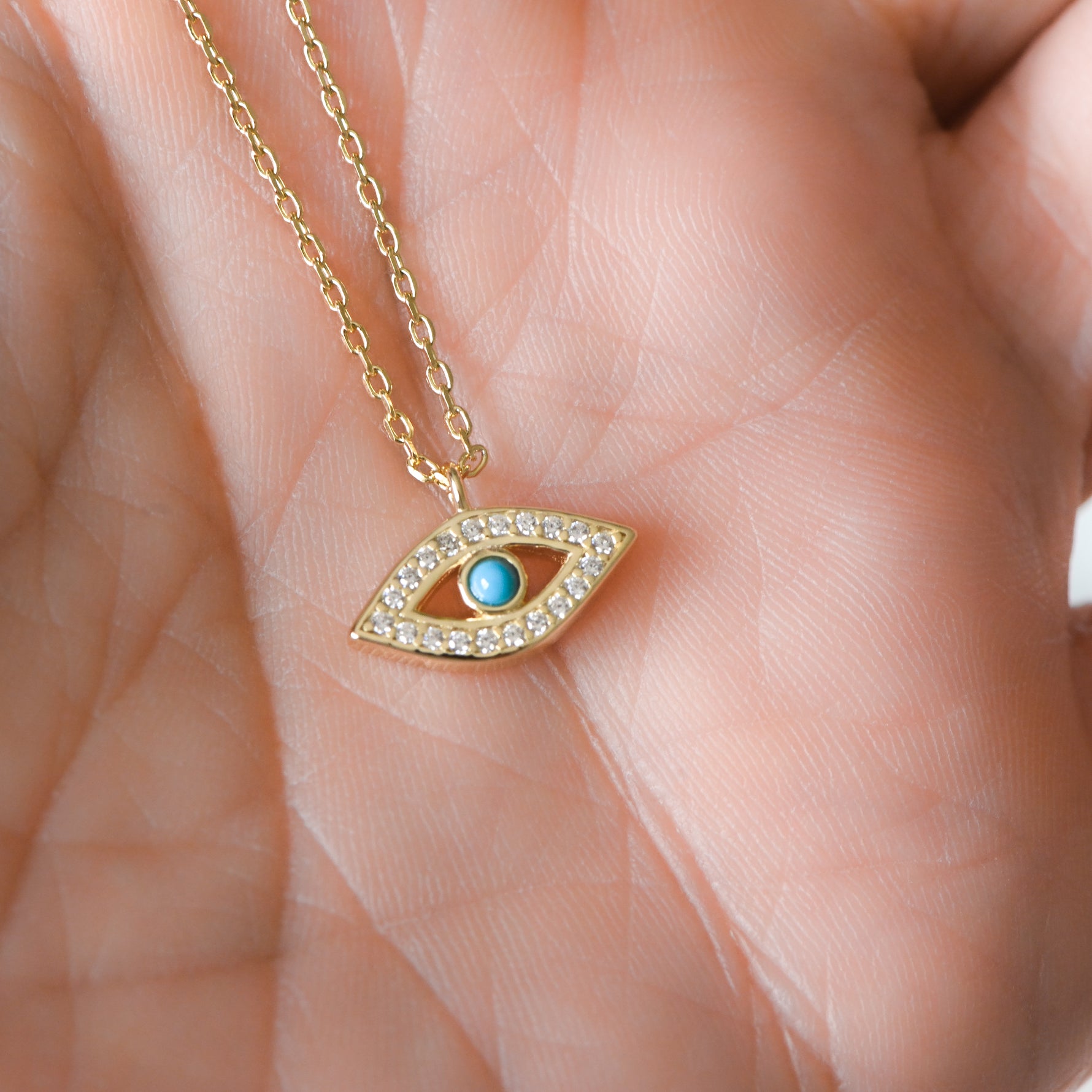 Turquoise evil eye pendant necklace in gold.