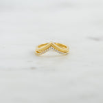 Upclose image of gold chevron ring set with one pavé band and one plain band.