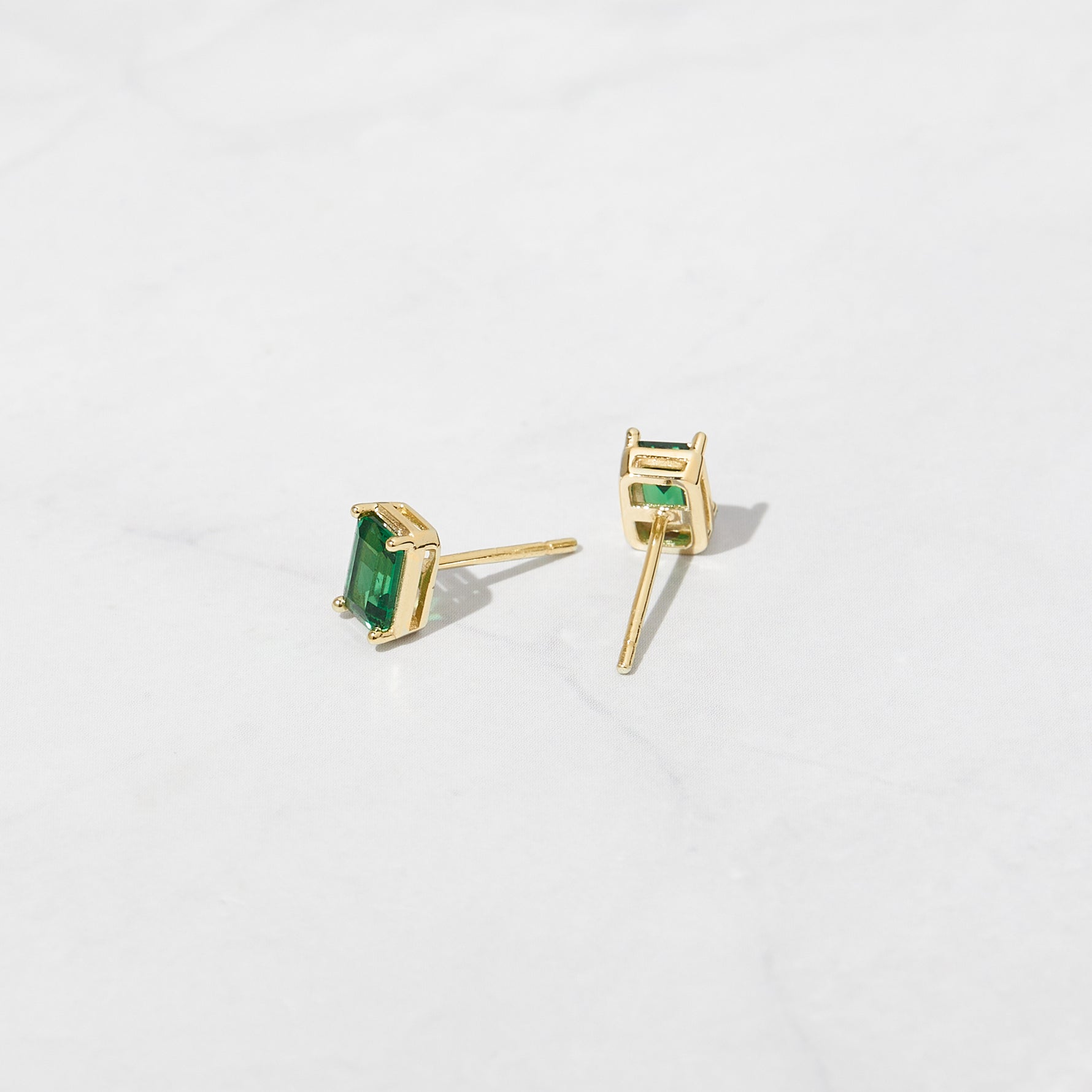 Green emerald cut stud earrings.