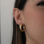 Model wearing Hailey Bieber Celebrity inspired hoop earrings. 