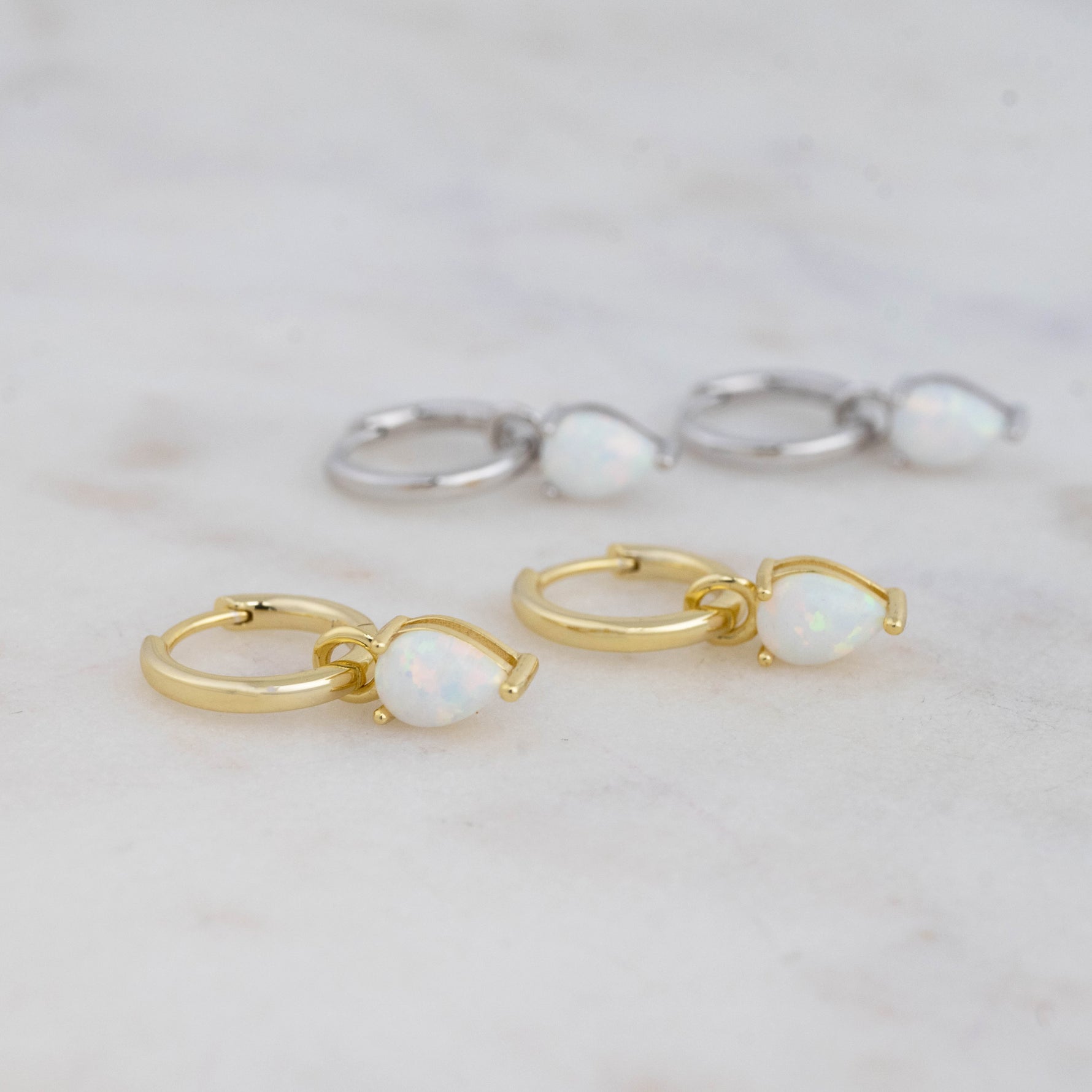 Gold and silver opal tear drop removable charm huggie earrings. 