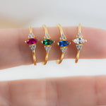 Marquise birthstone rings in gold featuring a ruby, emerald, sapphire, or diamond stone.