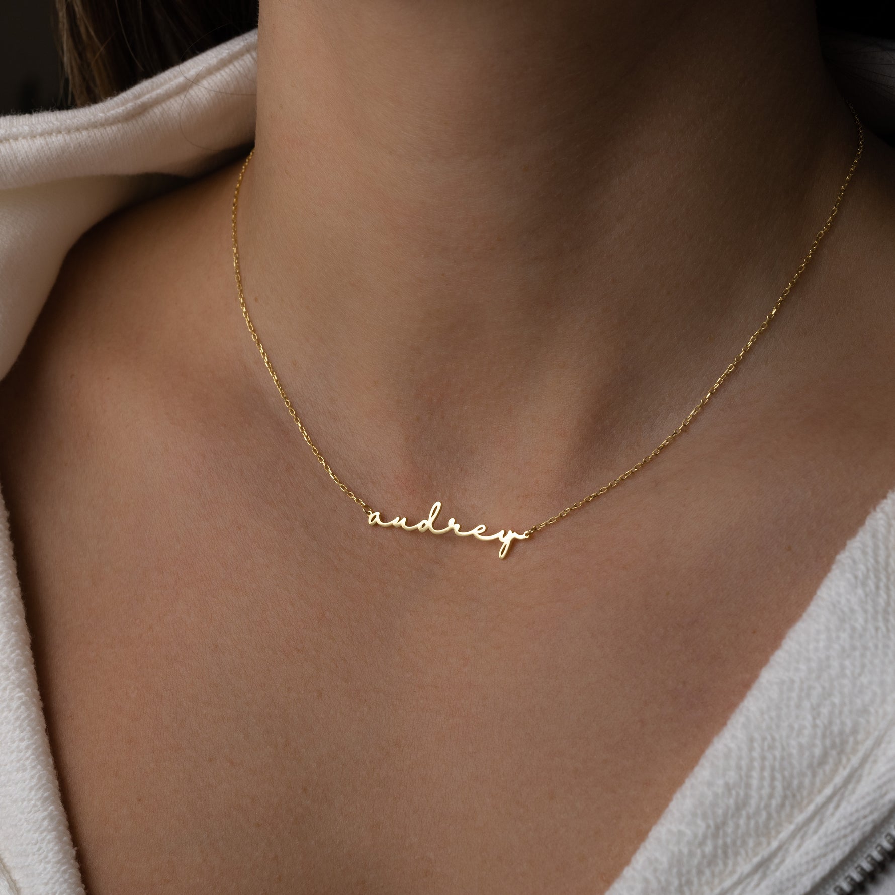Model script minimalist name necklace in gold