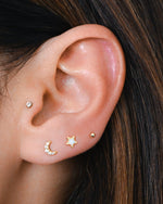 Model wearing gold celestial opal and cz stud earrings