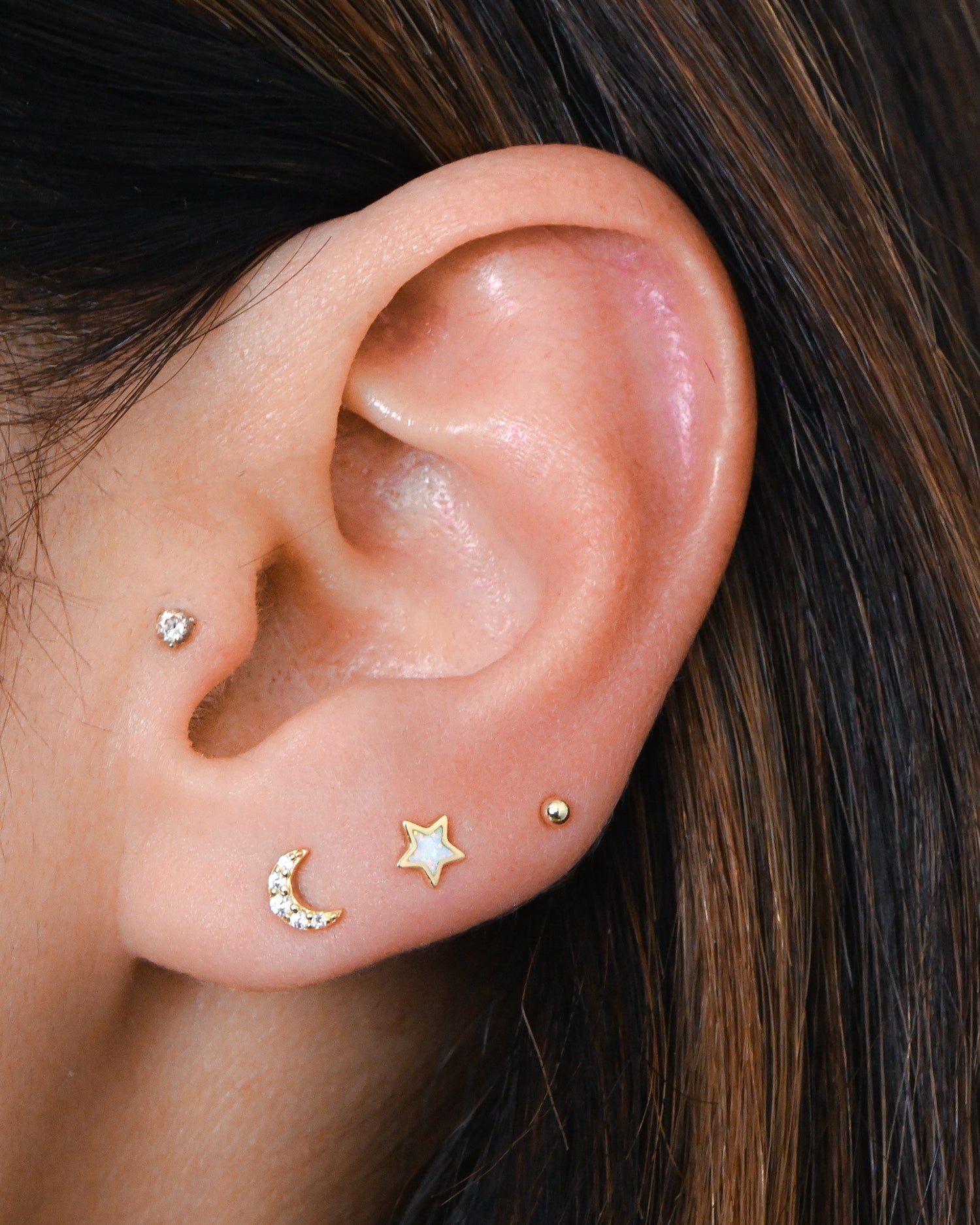 Model wearing gold celestial opal and cz stud earrings