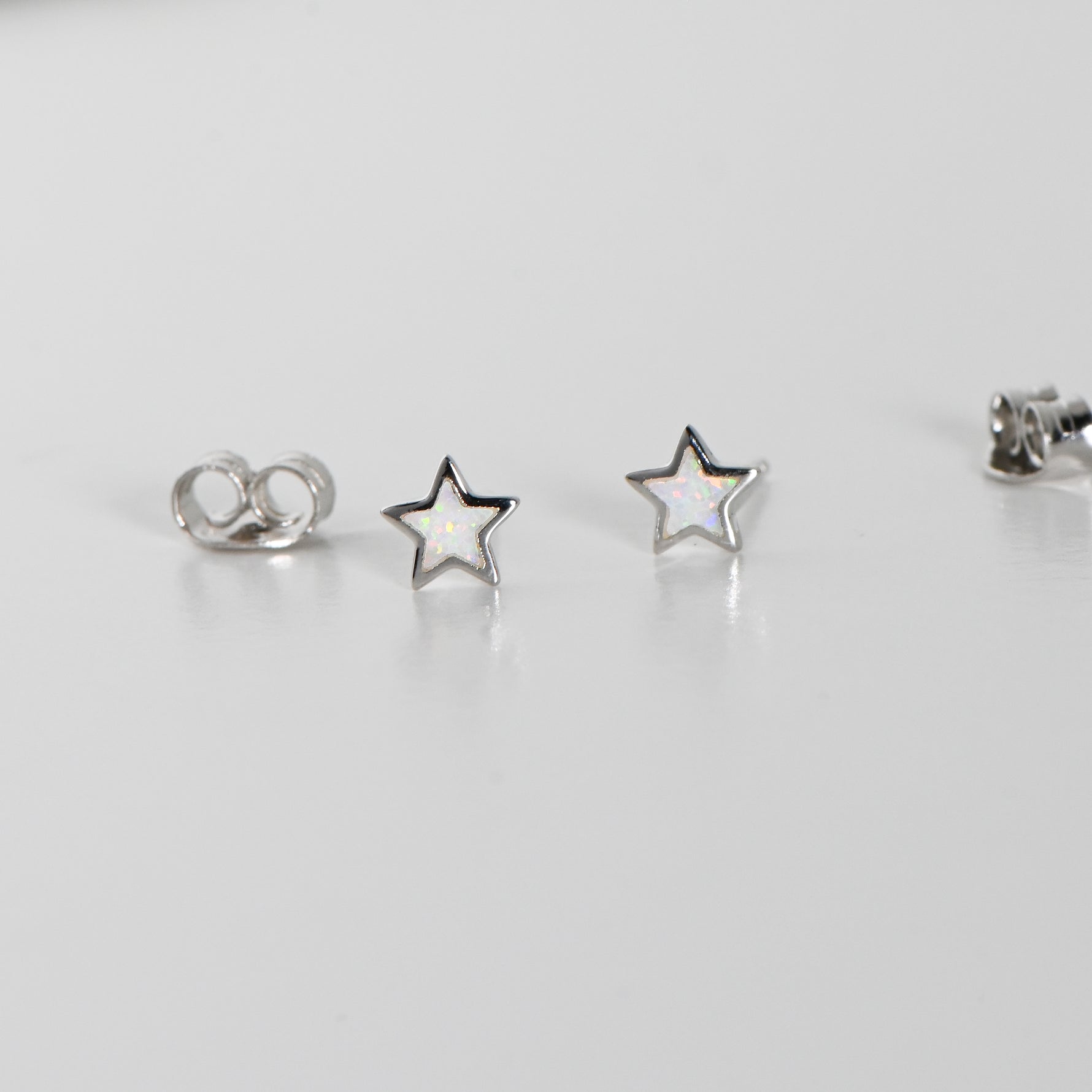 Silver star stud earrings in opal