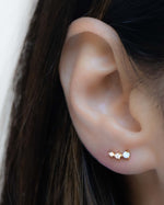 Model wearing minimalist opal birthstone stud ear climbers