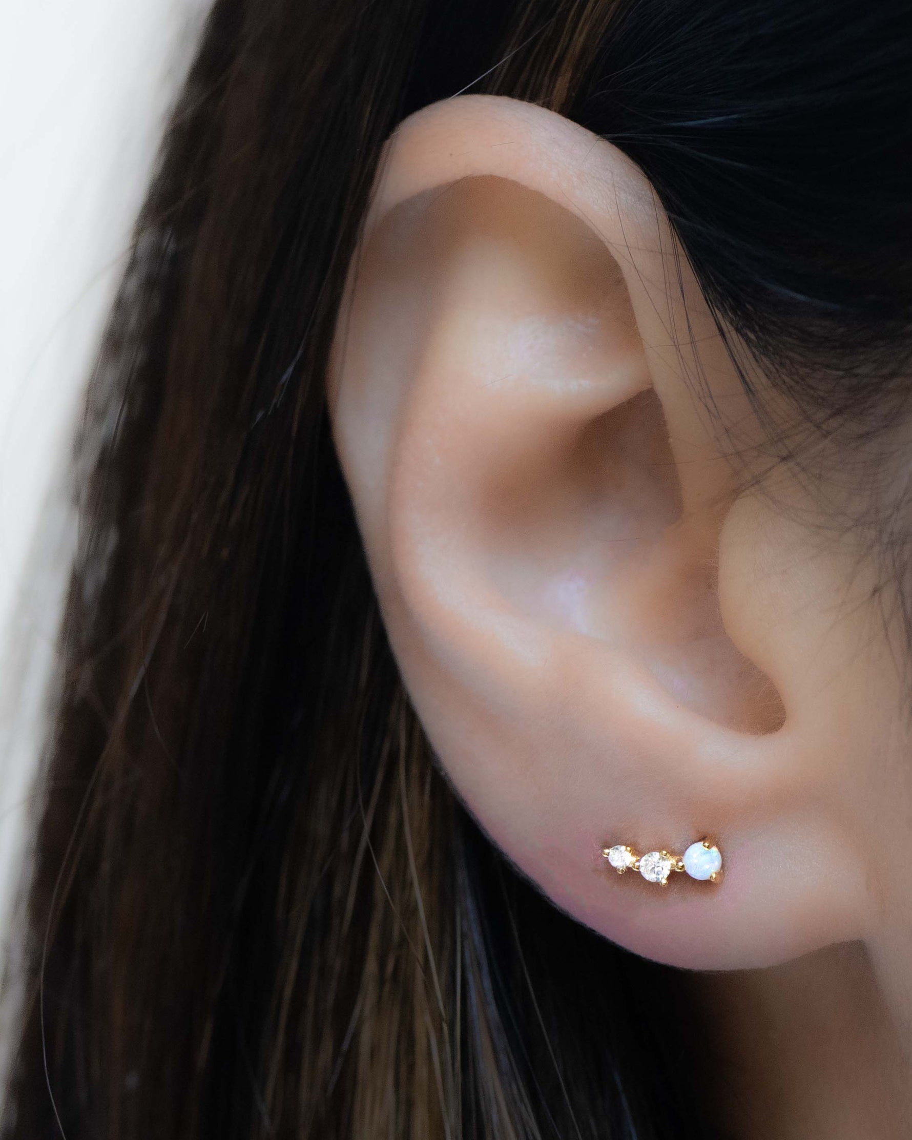 Model wearing minimalist opal birthstone stud ear climbers