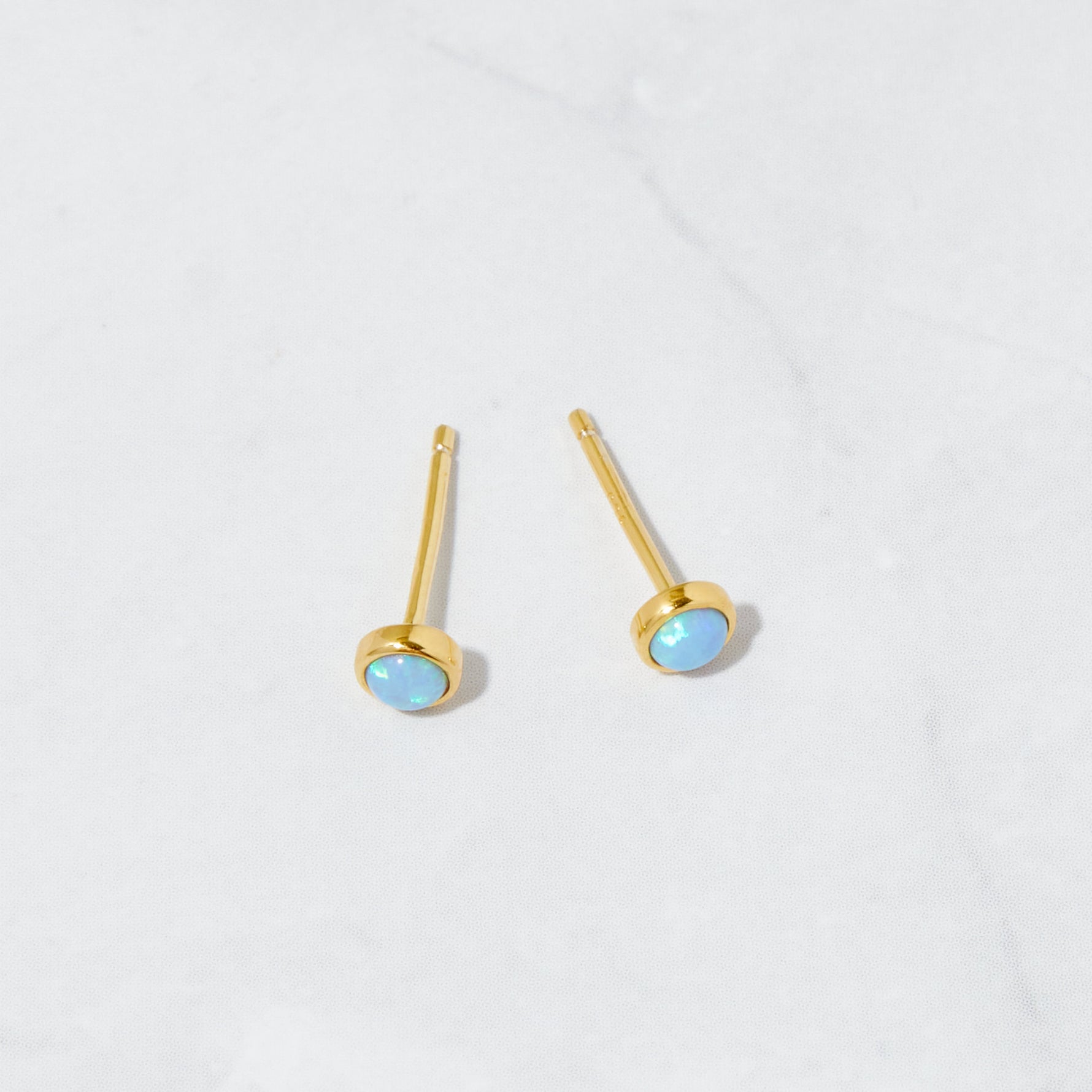 Gold dainty opal blue stud earrings