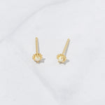 Tiny 14k gold plated opal vibrant stud earrings on marble background.
