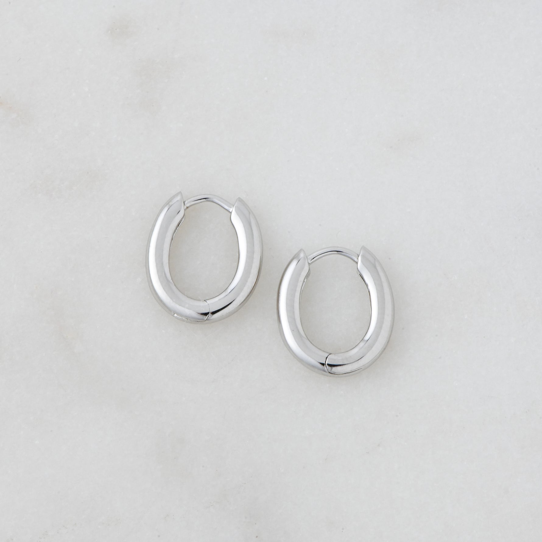 Simple oval sterling silver huggie hoops