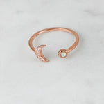 Upclose shot of rosegold opal and cz adjustable moon ring.