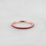 Rosegold ruby eternity gemstone band.