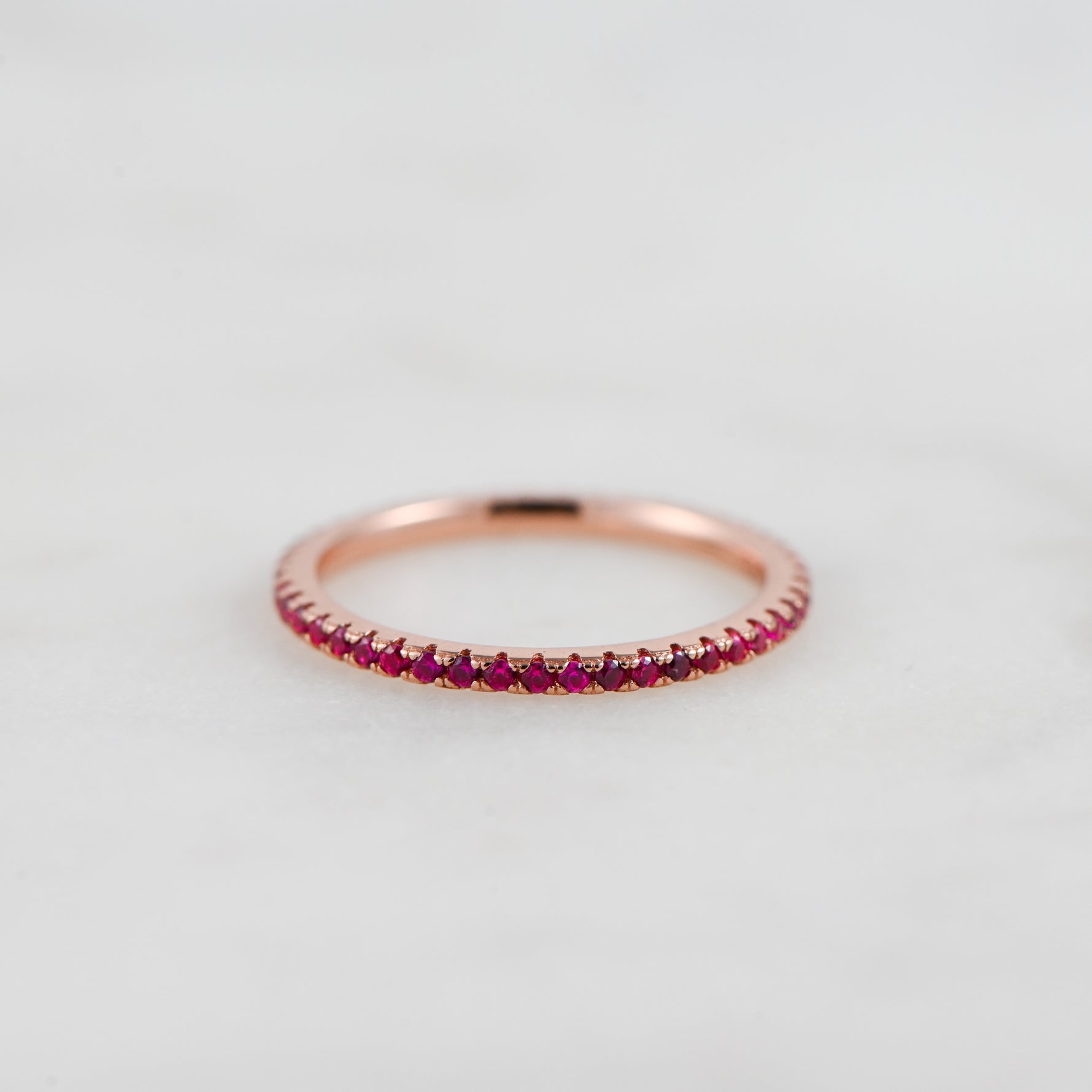 Rosegold ruby eternity gemstone band.