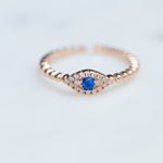 Dainty rose gold beaded evil eye ring with sapphire gemstone center. 