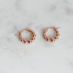 Rose gold beaded gradient hoop earrings.