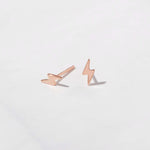 Rose gold dainty lightning bolt stud earrings. 