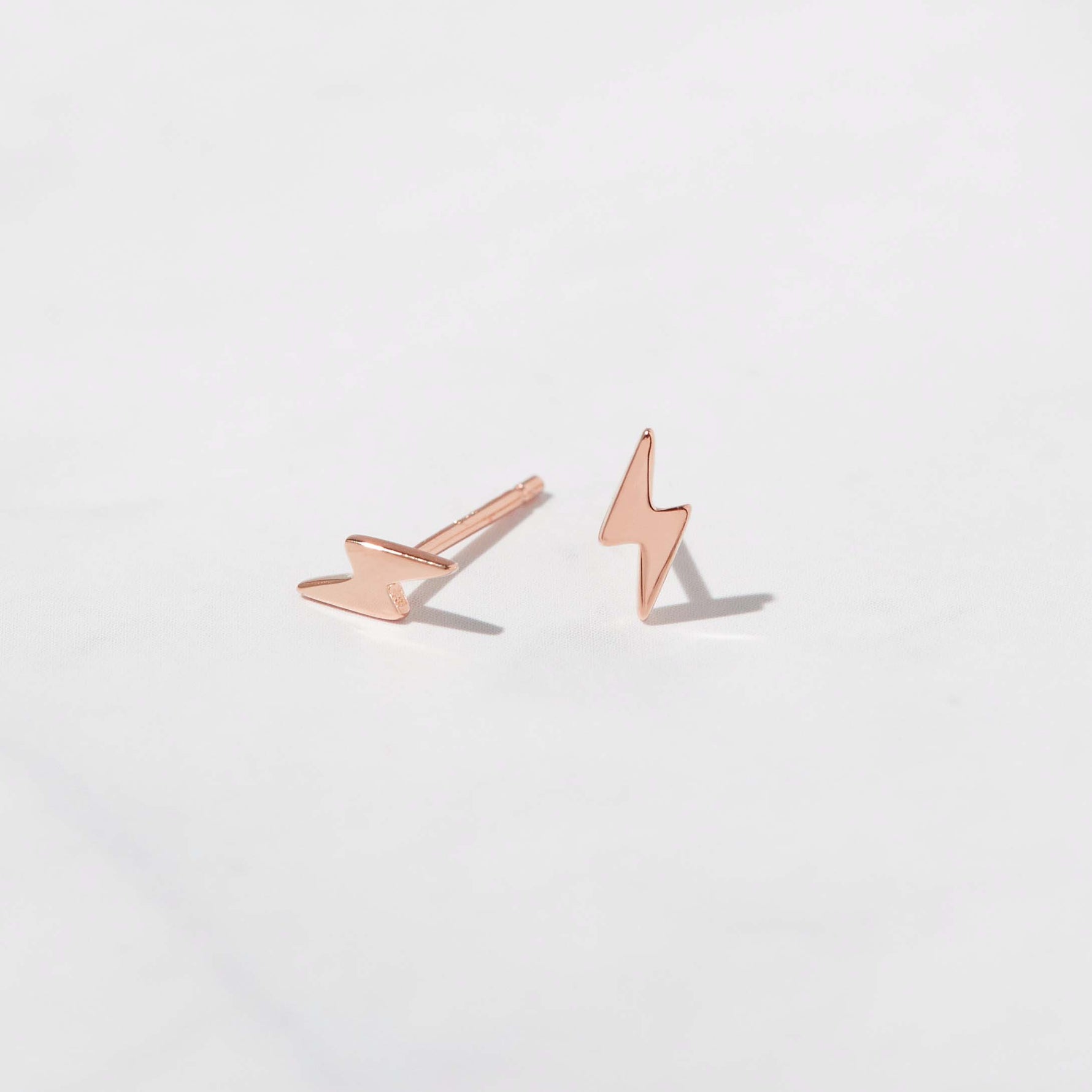 Rose gold dainty lightning bolt stud earrings. 