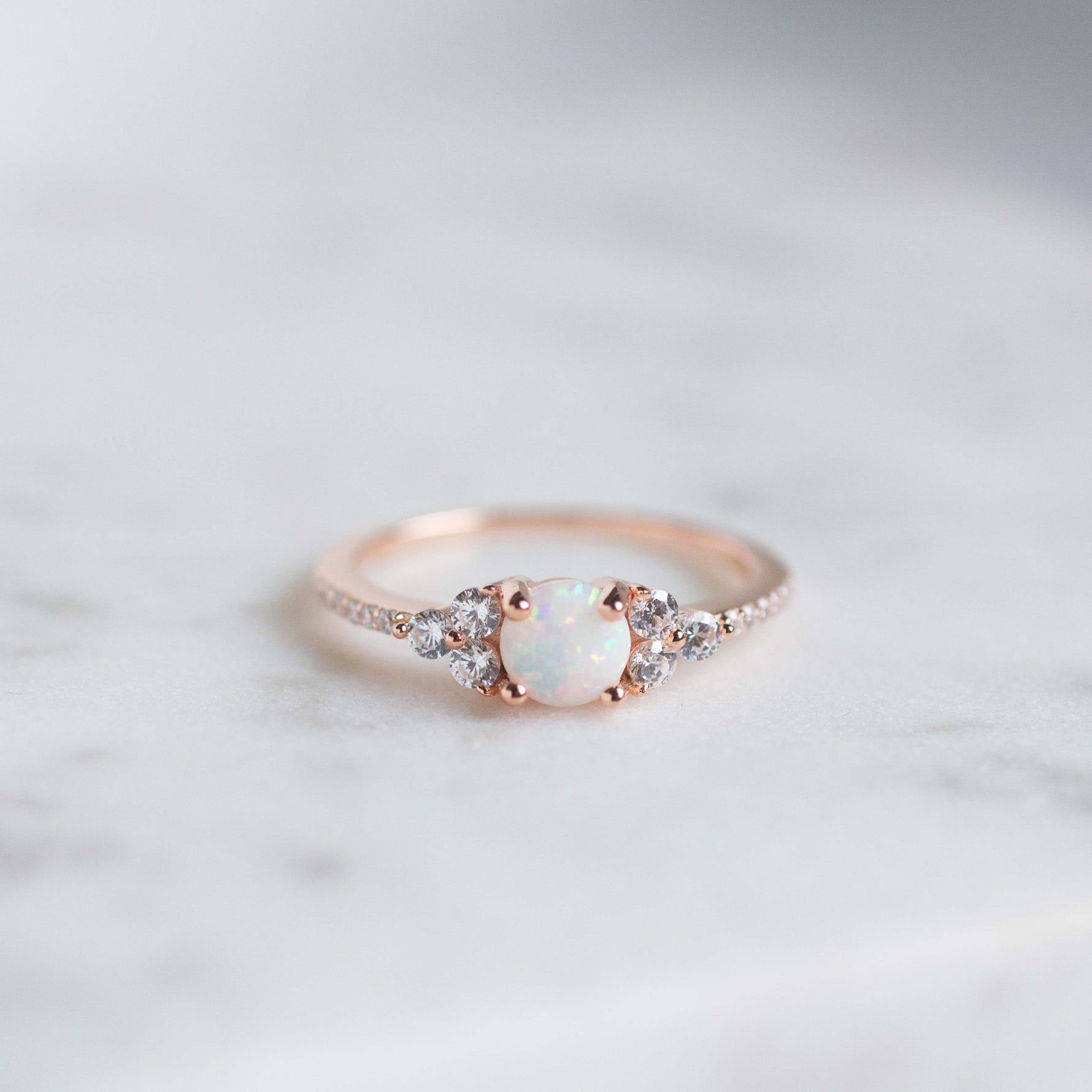 Rose gold stacking ring with opal center stone and cz diamonds. 