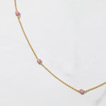 Close-up of ruby ball beaded chain necklace. 