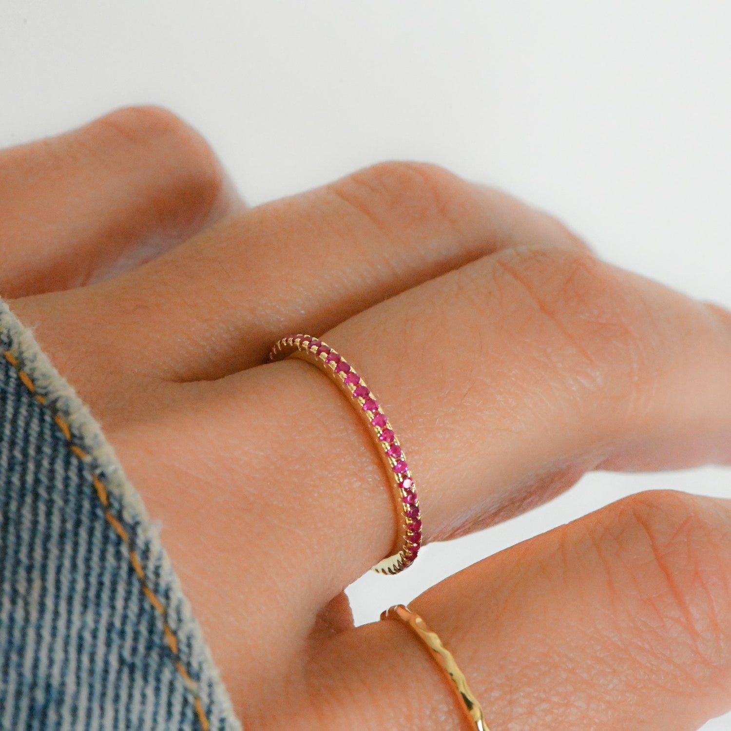 Model wearing minimalist ruby birthstone ring.