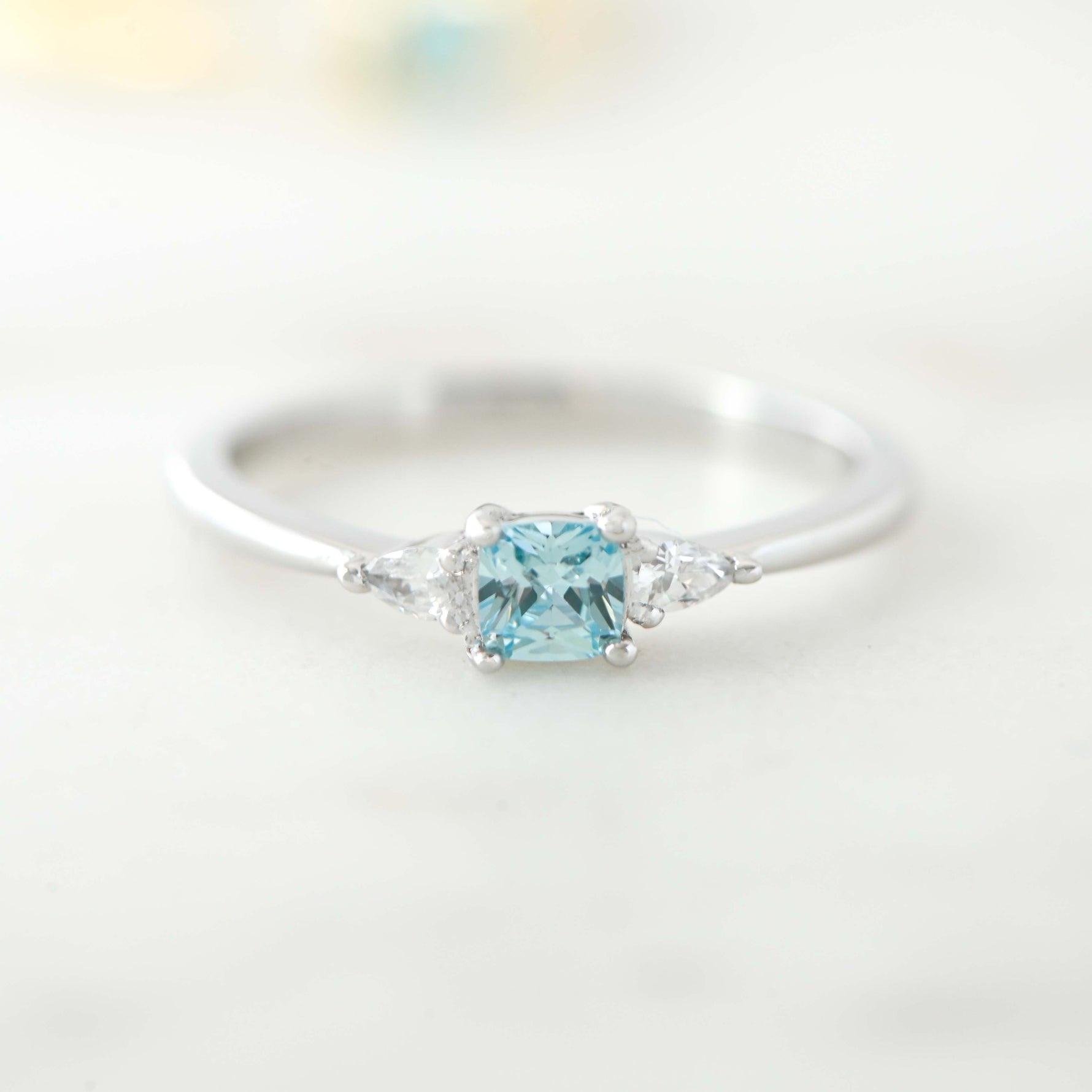 Upclose image of aquamarine cushion cz ring in sterling silver. 