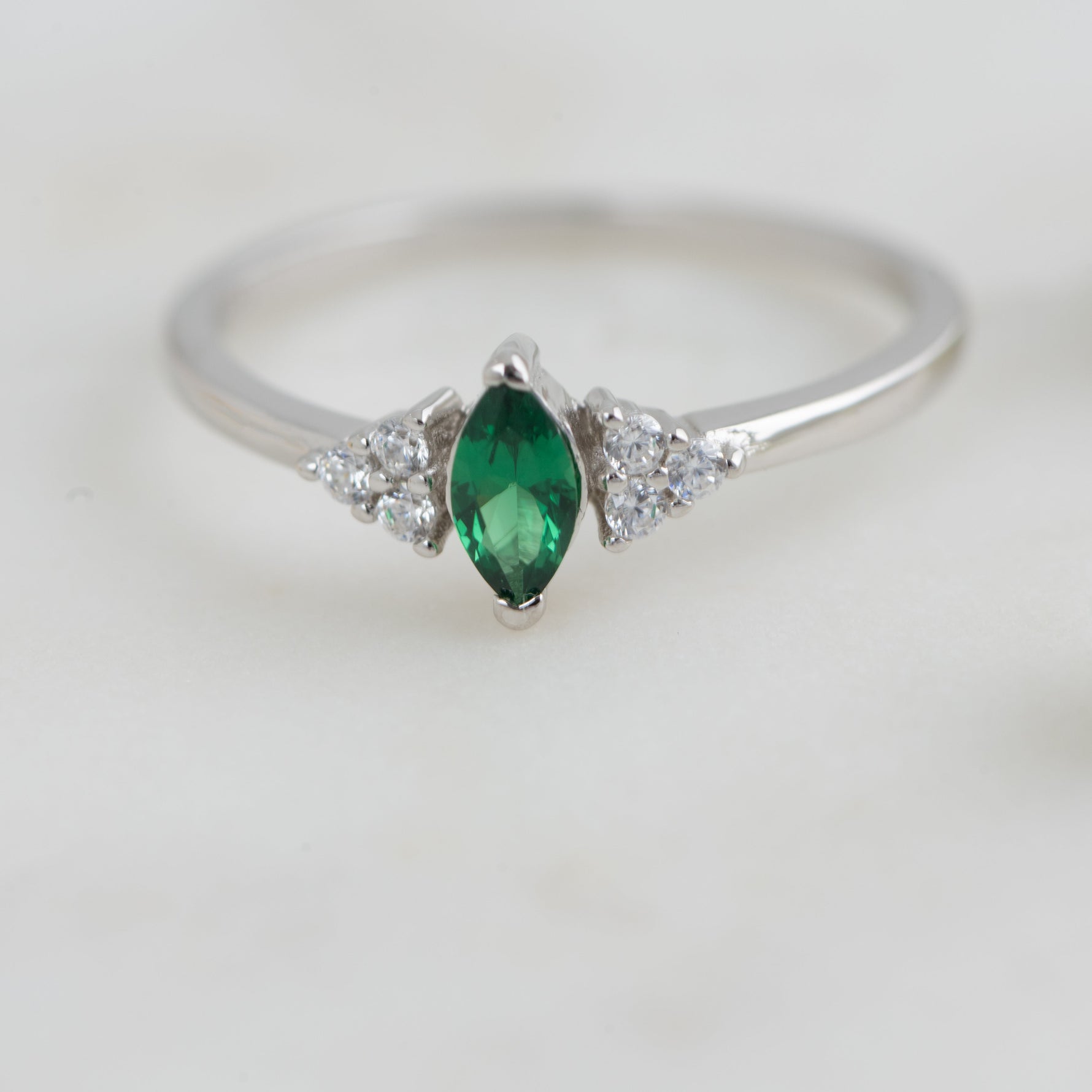 Upclose shot of sterling silver marquise emerald ring. 