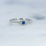 Upclose shot of sterling silver adjustable evil eye ring on marble background. 