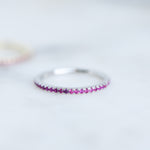 Upclose shot of ruby eternity birthstone ring. 