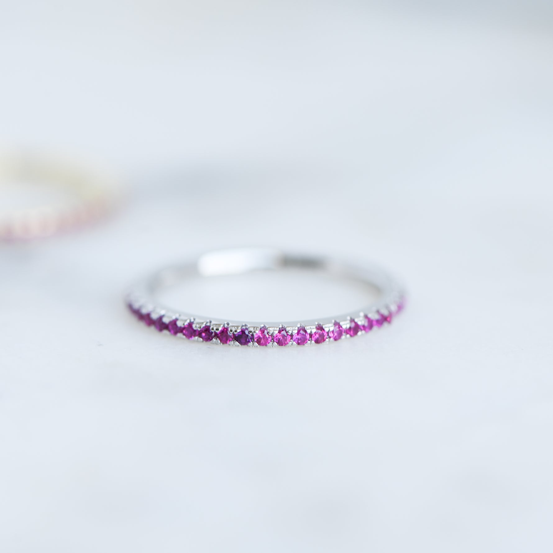 Upclose shot of ruby eternity birthstone ring. 