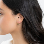 Model wearing beaded gold hoops 