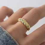 Model wearing trendy gold croissant ring. 