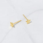 Up-close image of gold plain star stud earrings from the above angle, revealing the gold post. 
