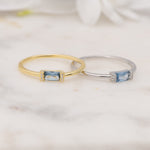 Gold and silver aquamarine baguette birthstone rings. 