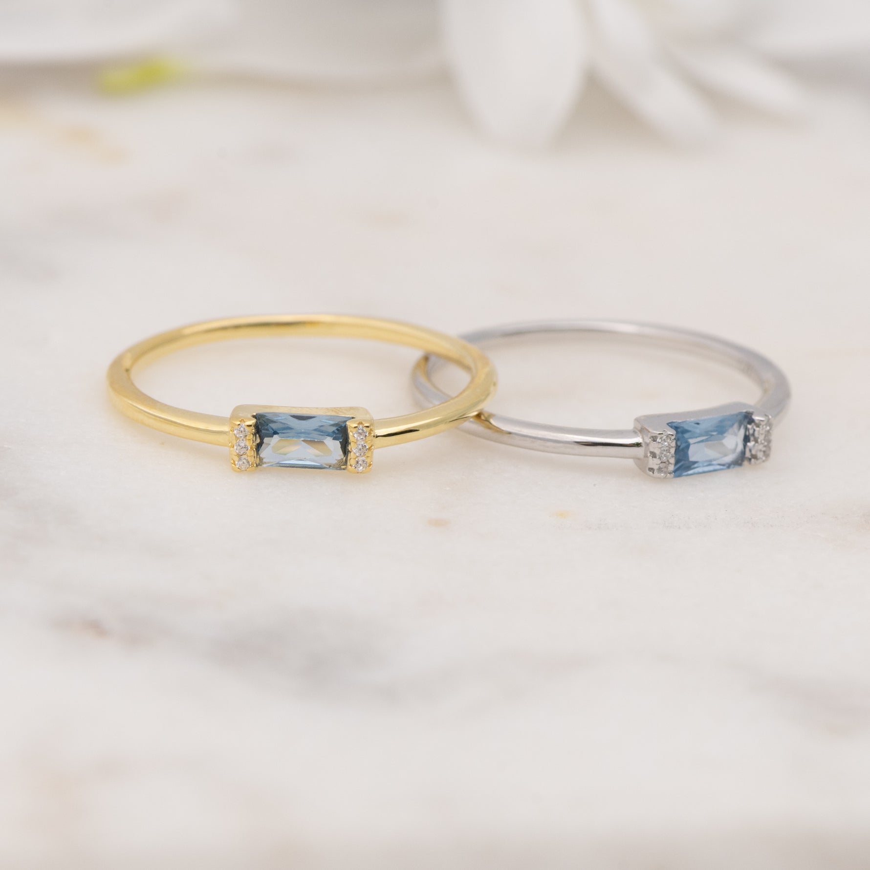 Gold and silver aquamarine baguette birthstone rings. 