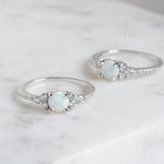 Delicate silver opal stone with cz diamonds surrounding the gemstone ring.