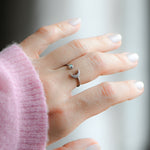 Model wearing opal and cz silver moon ring with adjustable band. 