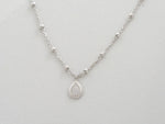 Up-close of tear drop silver pendant.