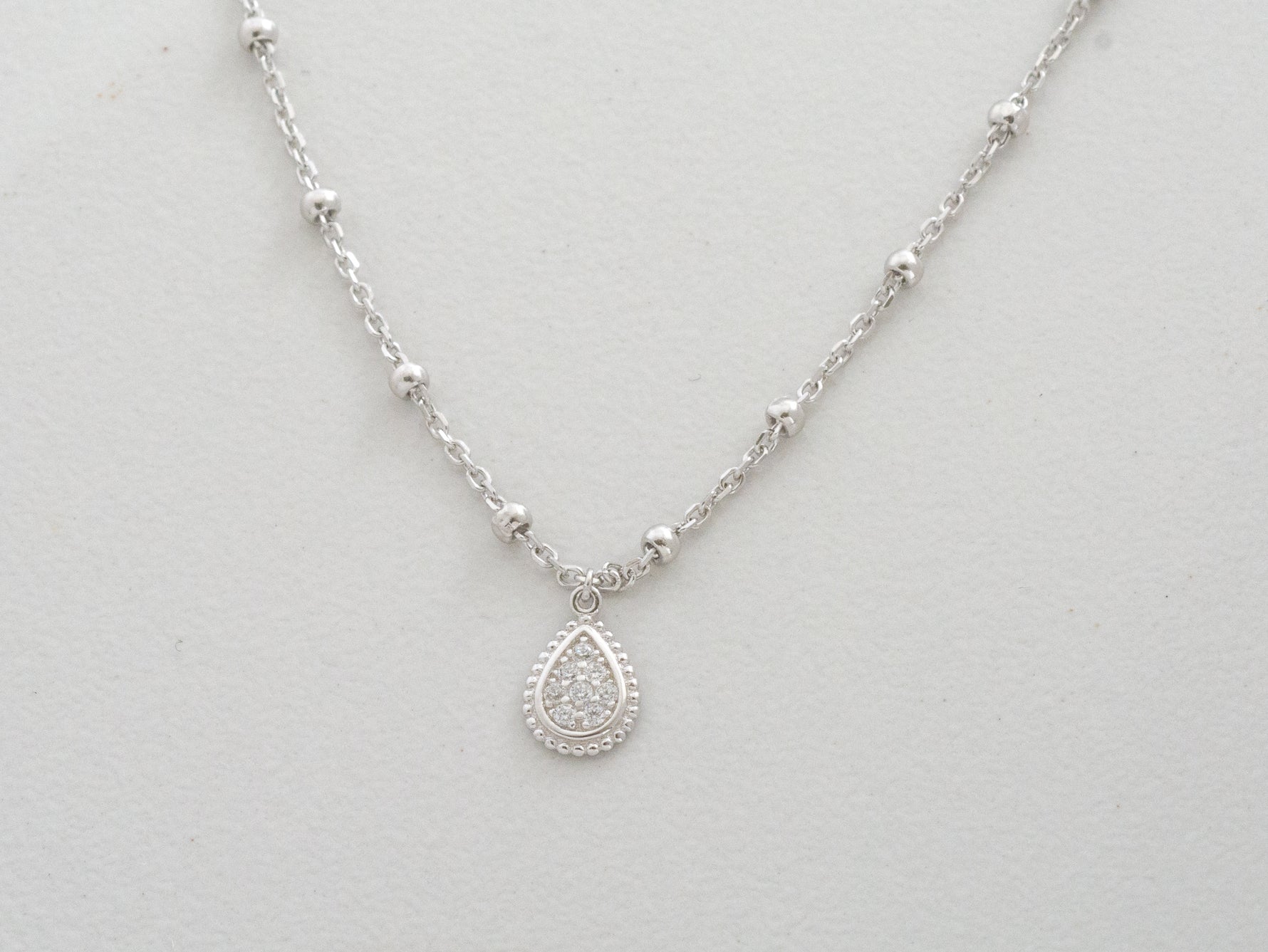 Up-close of tear drop silver pendant.