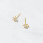 Small gold flower diamond stud earrings. 