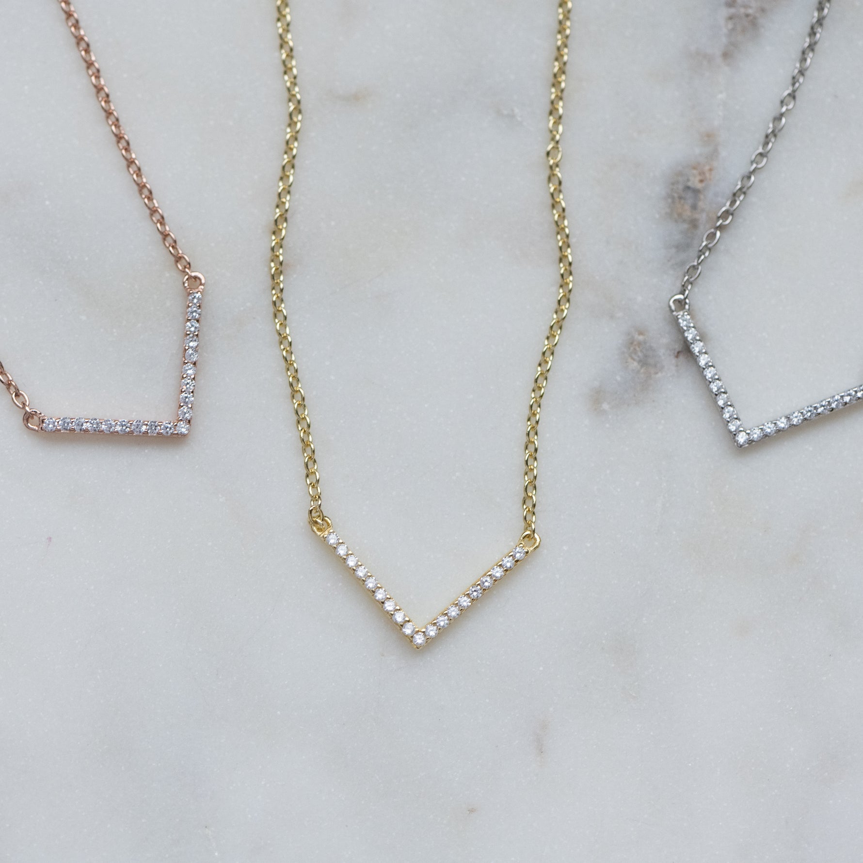 Chevron necklace in gold, rose gold, and silver.