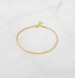 1.75mm Tennis Bracelet featuring brilliant cubic zirconia stones on a white background, showcasing minimalist design and elegant sparkle.