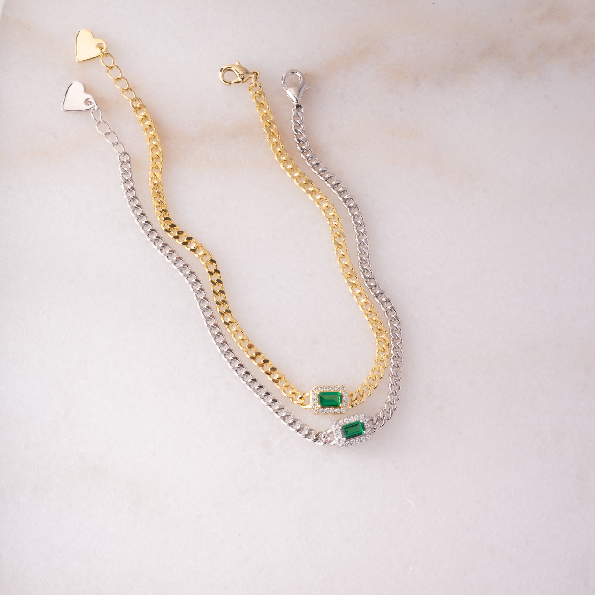 gold and silver emerald halo charm on curb chain bracelets